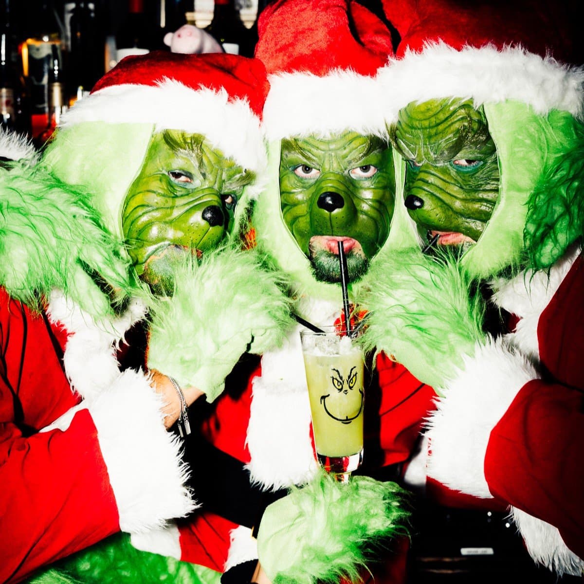 Three Grinches sharing a Grinch cocktail in The Cocktail Club