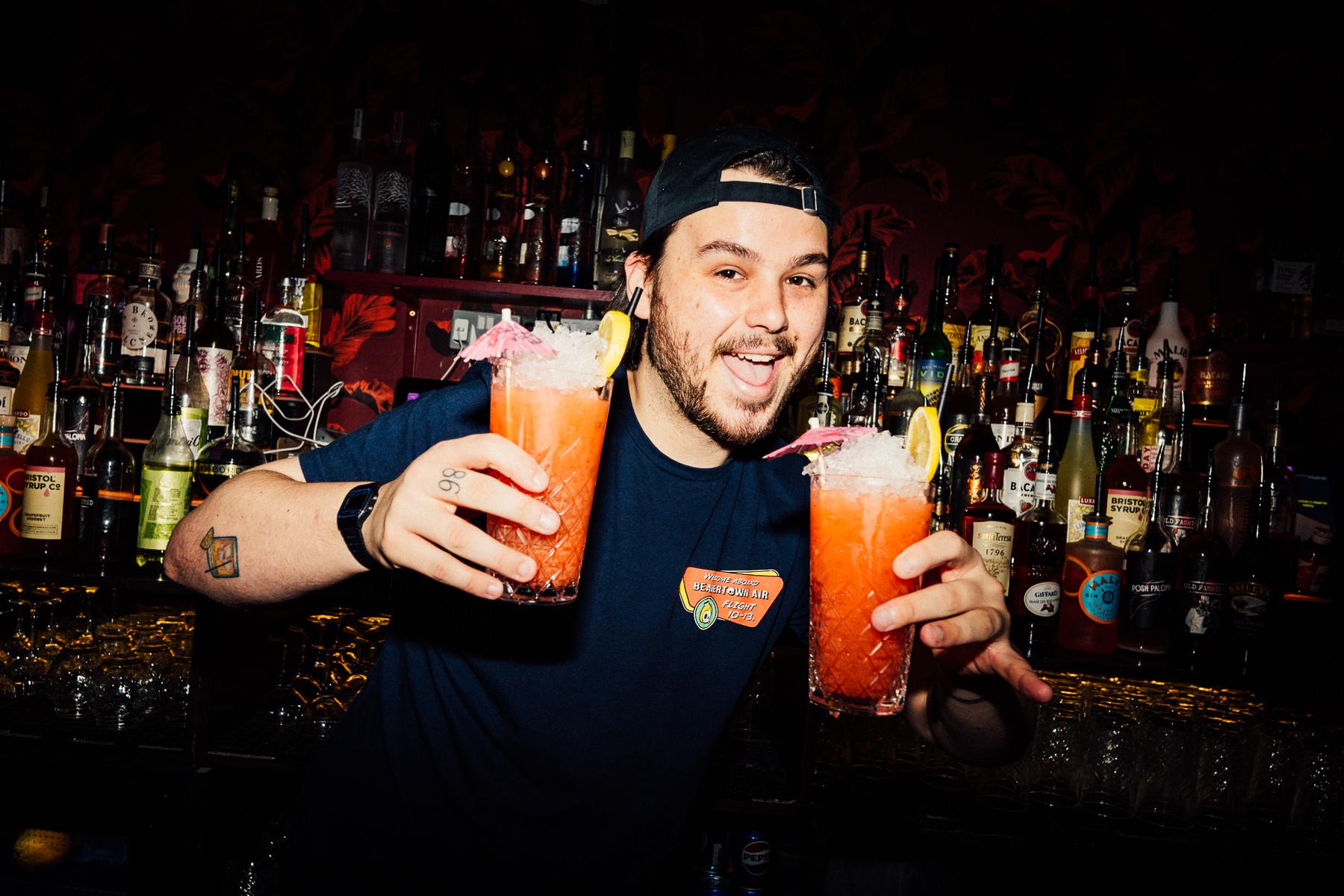 Bartender with two of the same cocktail for happy hour at The Cocktail Club